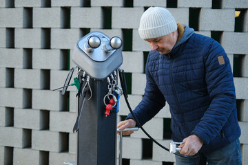 screwdrivers, wrenches, tire pump, man uses quick repair tool terminal to repair bicycles in urban...