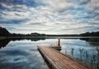 wooden jetty on the lake in summer, tranquil atmosphere by the lake, calm atmosphere, quiet...