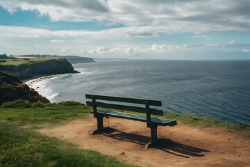 Empty bench on cliff overlooks peaceful sea, ideal for solitude