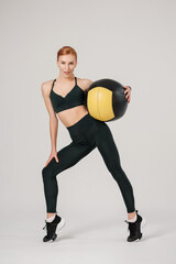 athletic female training with fit ball