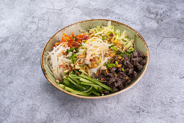 Bun Bo Nam Bo in a plate on a gray background
