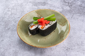 Onigirazu with salmon in a plate on a gray background