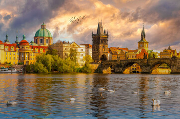 Sunrise over the Charles Bridge in Prague, with Swans and Gothic Towers nearby.