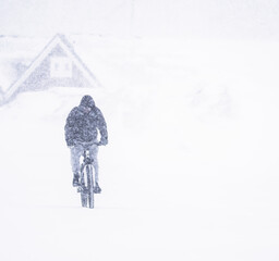 person riding a bike in snow - 772574158