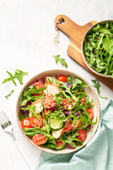 Green salad with baked chicken breast, fresh salad leaves and vegetables.