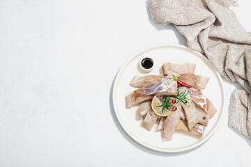 Raw pollock (Pollachius virens) fillet. Fresh fish for healthy food lifestyle. Spices and herbs