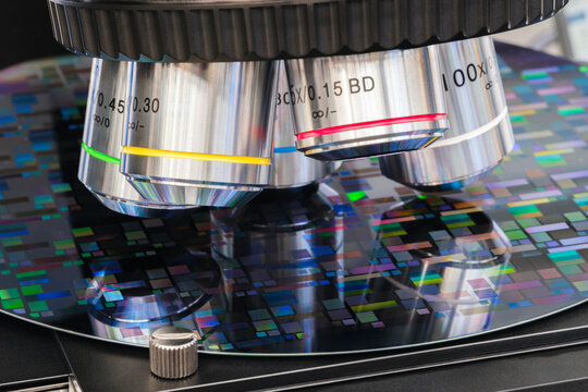 Close up examining test sample microchip transistor under microscope in laboratory. Equipment for testing microchips. Automation of production. Manufacturing microchips silicone wafer under microscope