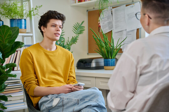 College student guy at meeting with professional counselor, social worker