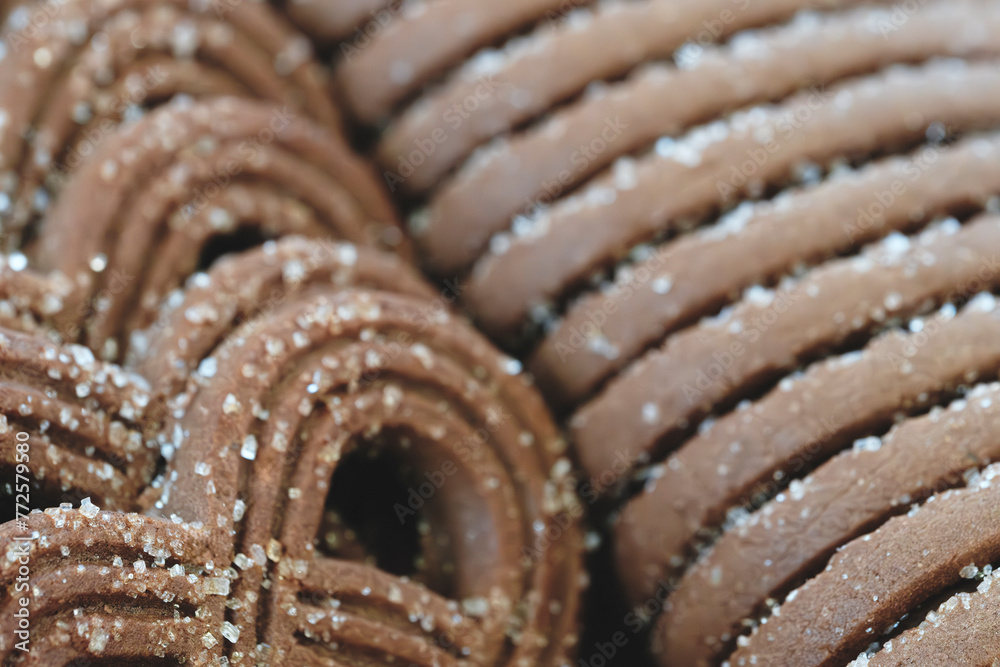 Leinwandbilder a close up of a bunch of chocolate cookies with sugar sprinkled on top. the cookies are stacked on t