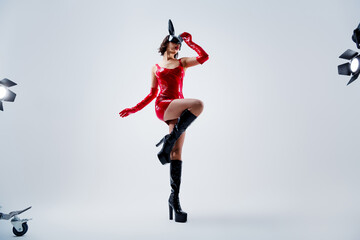 Full length photo of gorgeous girl dance striptease rabbit mask red leather outfit isolated on...