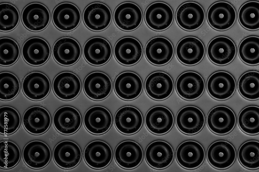Poster A black background of many circles of various sizes. The circles are all different sizes and are arranged in a pattern. The photo has a somewhat abstract and minimalist feel to it