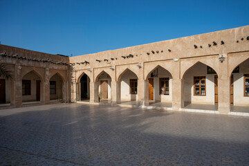Fototapeta na wymiar Wakra, Qatar - March 28, 2024: Old buildings architecture in the Wakrah souq (Traditional Market).