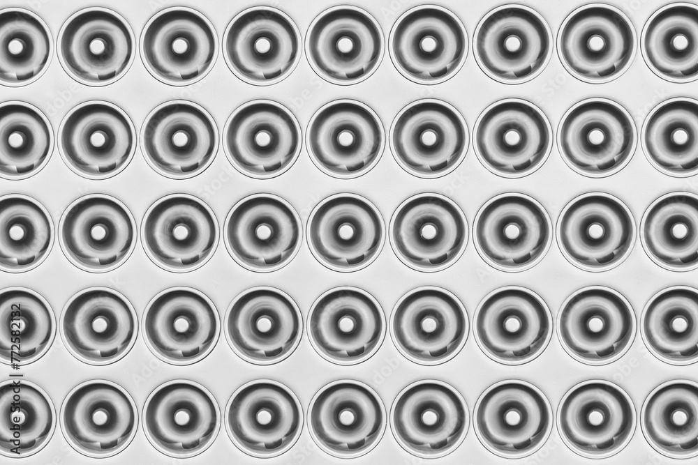 Poster A black and white background of many circles of various sizes. The circles are all different sizes and are arranged in a pattern. The photo has a somewhat abstract and minimalist feel to it