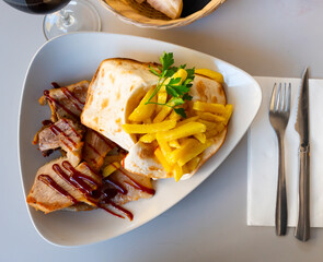 Delicious pork secret served with potatoes on plate in restaurant
