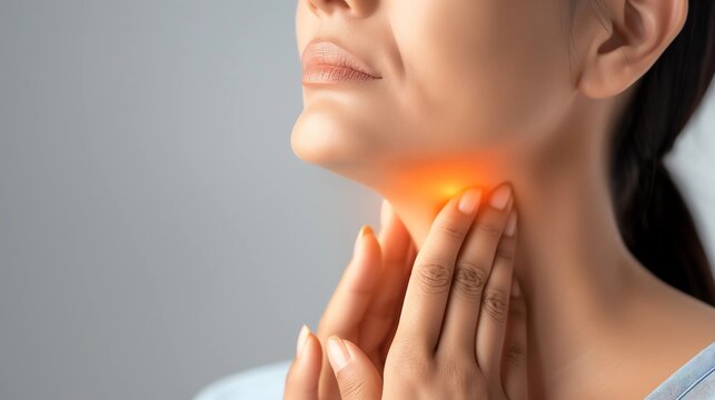 Woman showing painted thyroid gland on her neck.
