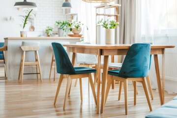 Fototapeta na wymiar Stylish Scandinavian dining room with a wooden table and blue chairs