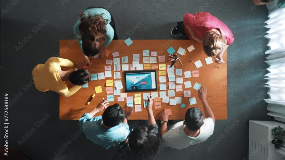 Poster top down view of programmer brainstorming and planning about web design while looking at tablet wire