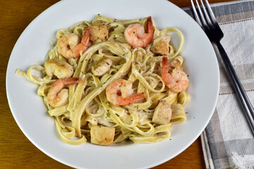 linguine alfredo top with  shrimp and chicken