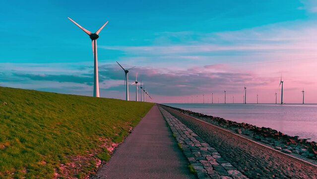 Aerial drone view wind turbine park ofsshore wind farm in the Netherlands on sunset. High quality 4k footage