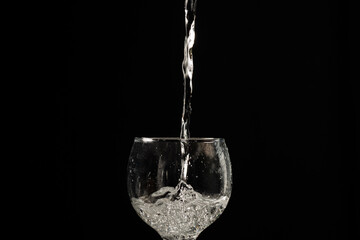 Water falling into a glass cup.