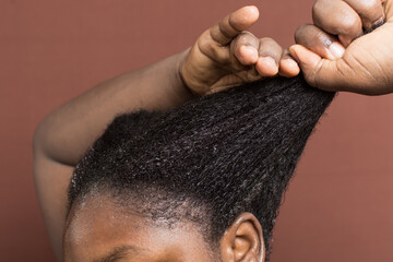 Black afro curly hair with shrinkage, Wet Type 4c hair being detangled