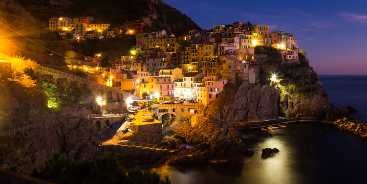 The colorful houses of Manarola, La Spezia in evening from sea view at Italy