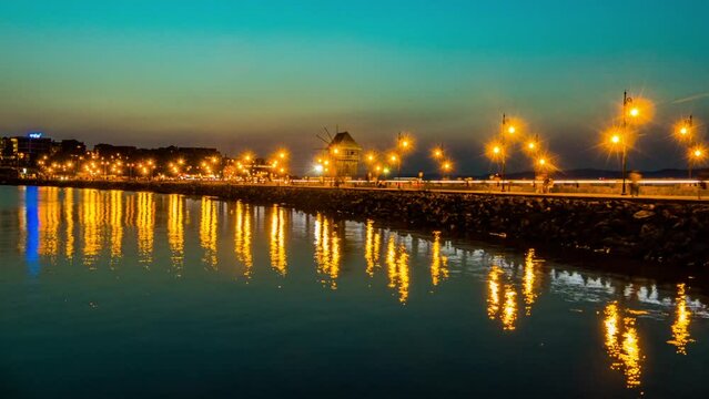 Windmill and bridge, which leads to the old town of Nessebar, Bulgaria, night illumination.