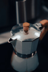 Old inox domestic espresso coffee machine in a kitchen