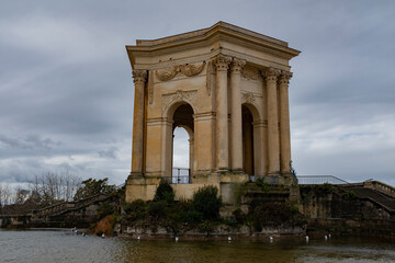 Fototapeta na wymiar Montpellier famous old stone arch landmark in a beautiful park on a cloudy day