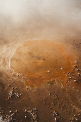 Close up view of a small orange geyser in Tatio geysers in the Atacama desert, Chile