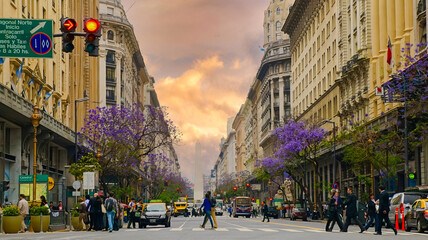 Bustling European-Style Boulevard with Jacaranda Trees in a Spanish-Speaking City at Sunset
