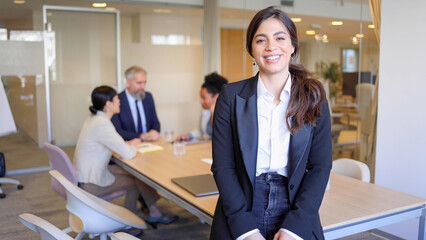 Portrait of a beautiful, young businesswoman standing at the office of her company