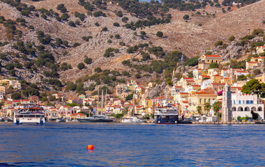 Multi-colored facades of houses in the Greek village Symi on a sunny day - 772603352