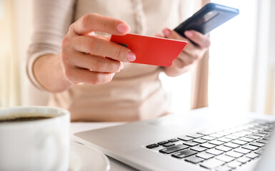 Girl with laptop and credit card shopping online