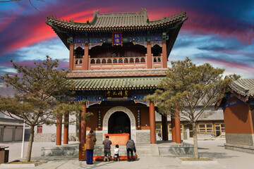 Vibrant Traditional Chinese Temple Gate at Sunset, Cultural Heritage Site, China with Visitors