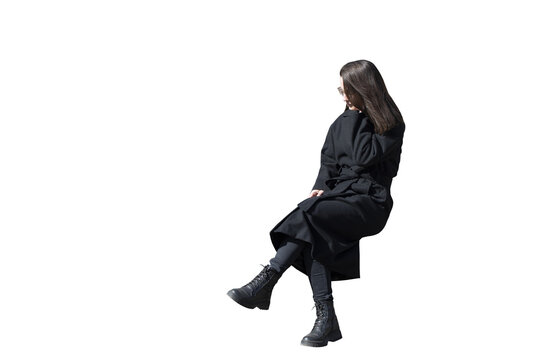 A woman in black coat in sitting pose isolated
