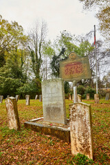 Civil war graveyard from 1864 in Madison Georgia with tombstones for Confederate and one unknown soldier on a rainy and gloomy spring day