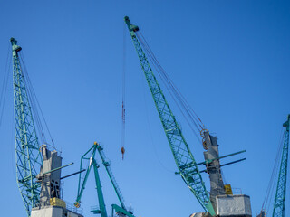 Marine cranes. Loading heavy loads. Cranes against the sky.