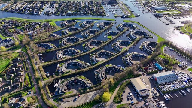 Aerial drone view geometric pattern of water houses, marina, yachts Marina Park Lemmer Netherlands. High quality 4k footage