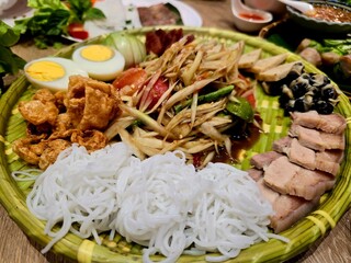 A delicious Thai-inspired rice meal with chicken, pork, shrimp, and fresh vegetables
