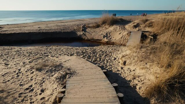 there is a wooden walkway leading to the beach