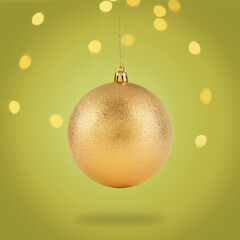 Beautiful golden Christmas ball hanging on color background