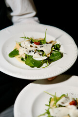 salad with squid in the waiter's hands