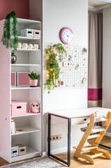 desk and wardrobe for children's room in white and pink colors without people