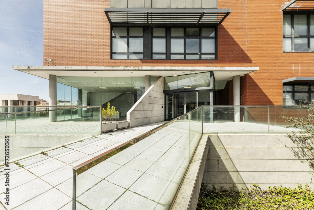 Wall mural access walkway to an office building with tempered glass railings and metal edges