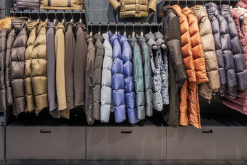 A shelf and drawers full of anoraks and puffer coats in a clothing store © Toyakisfoto.photos