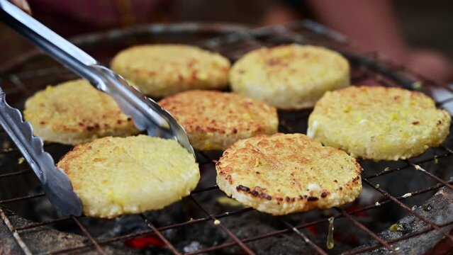 Grilled sticky rice dipped in egg or Khao jee on the grill, this type of food is commonly eaten by rural Thai people.