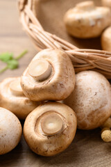 Fresh Champignon mushroom or button mushroom on wooden background