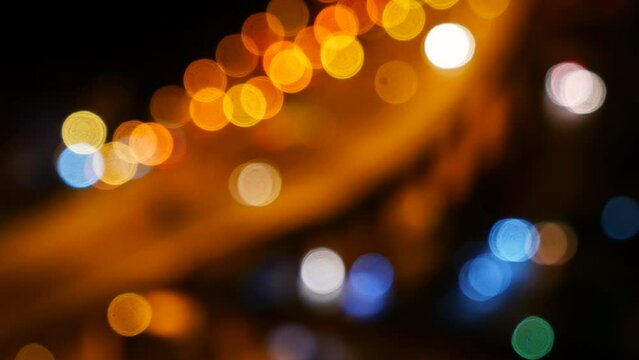 Blurred background night city bokeh car drive on road in nightlife. Light line traffic jam in black night. Blur street flare traffic motion movement. Cityscape Urban dark background twilight time