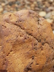 abstract Textured background with round pebble stones. Vacation holiday recreation on beach concept. High quality photo. Fragment with a texture of rock. surface  stone wall with cracks.